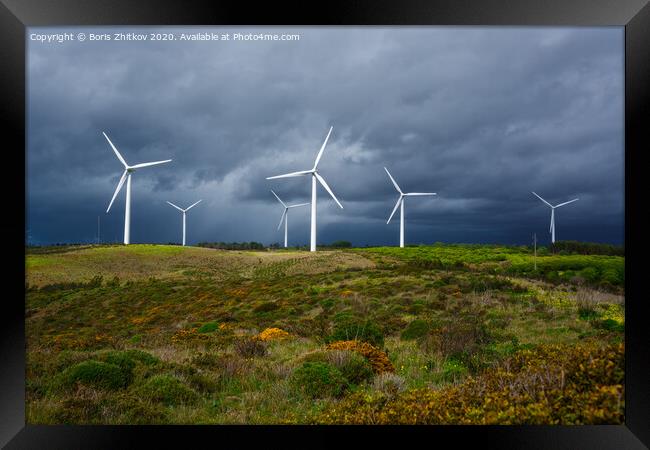 Windmills against dramatic sky. Framed Print by Boris Zhitkov