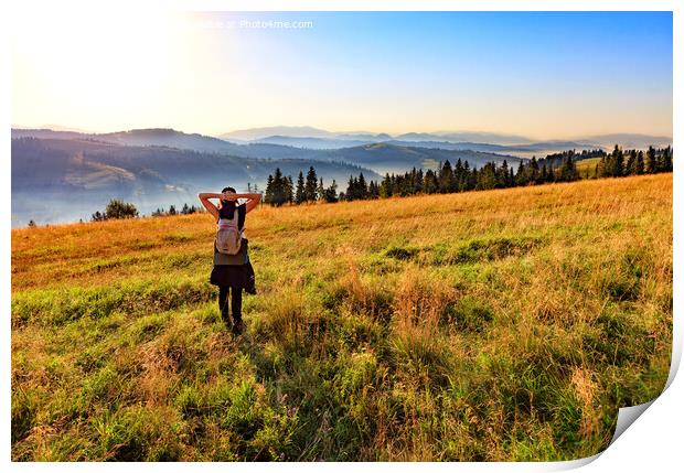 Young woman inhales the aroma of wild herbs and flowers at sunrise on a hilltop in the Carpathians. Print by Sergii Petruk