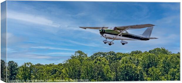 Green and White Plane in Flight Canvas Print by Darryl Brooks