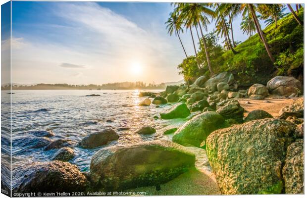 Tropical sunrise over rocks Canvas Print by Kevin Hellon