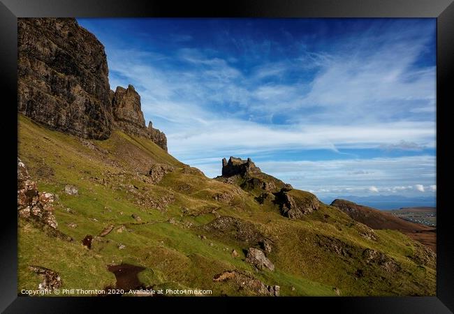 Blue skies over the Quiraing cliffs, Skye. Framed Print by Phill Thornton