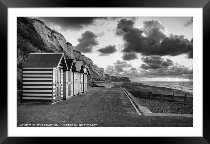 Cromer beach huts at sunset monochrome Framed Mounted Print by David Powley