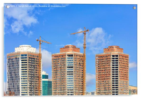 The construction of modern residential skyscrapers with a glass facade and tower cranes against the blue sky. Acrylic by Sergii Petruk