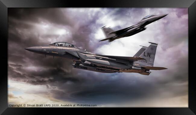Two F-15E fighter jets passing in storm clouds Framed Print by Simon Bratt LRPS