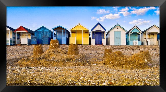 Beach huts and sandcastles at Thorpe Bay, Thames Estuary, Essex, UK. Framed Print by Peter Bolton