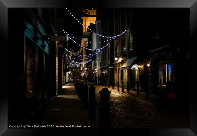 Cobblestones and Christmas lights Framed Print by Sara Melhuish