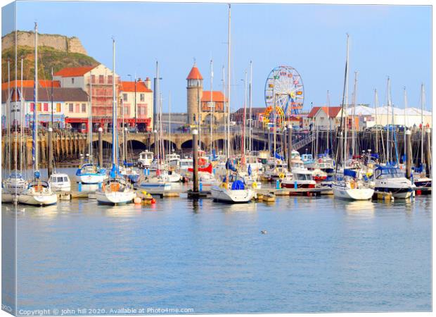 Harbour marina and funfair at Scarborough in Yorkshire.  Canvas Print by john hill