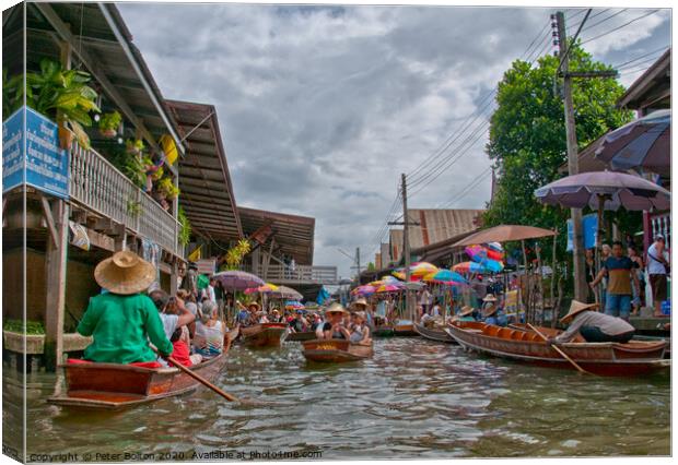 A floating market in Bangkok, Thailand. Canvas Print by Peter Bolton