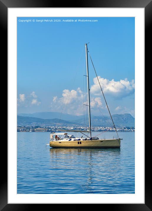 Sailing yacht anchored in the background of mountains and morning haze in the Corinthian bay. Framed Mounted Print by Sergii Petruk