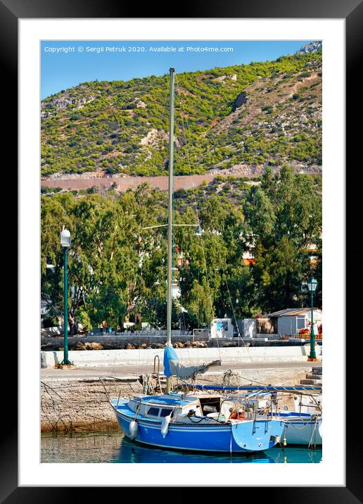 A small sailing yacht moored in the picturesque bay of the Ionian Sea, Loutraki, Greece. Framed Mounted Print by Sergii Petruk