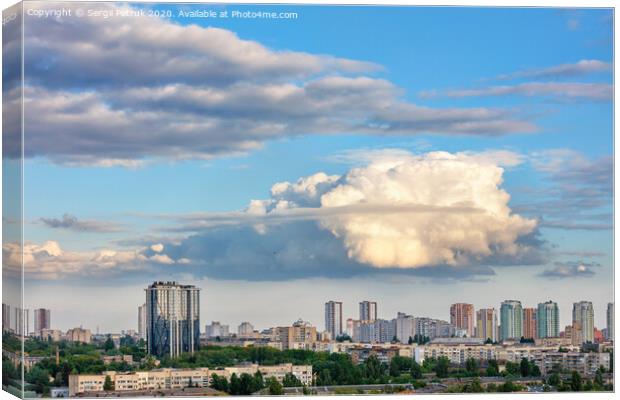 A large curly figured cloud hung over the city. Canvas Print by Sergii Petruk