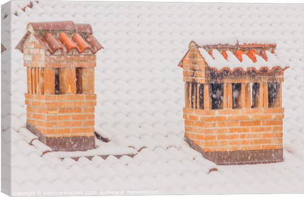 the chimneys of a house during a heavy snowfall Canvas Print by susanna mattioda