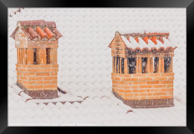 the chimneys of a house during a heavy snowfall Framed Print by susanna mattioda
