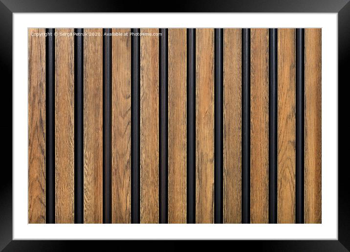 A fence made of vertical wooden decorative strips located parallel to each other. Framed Mounted Print by Sergii Petruk