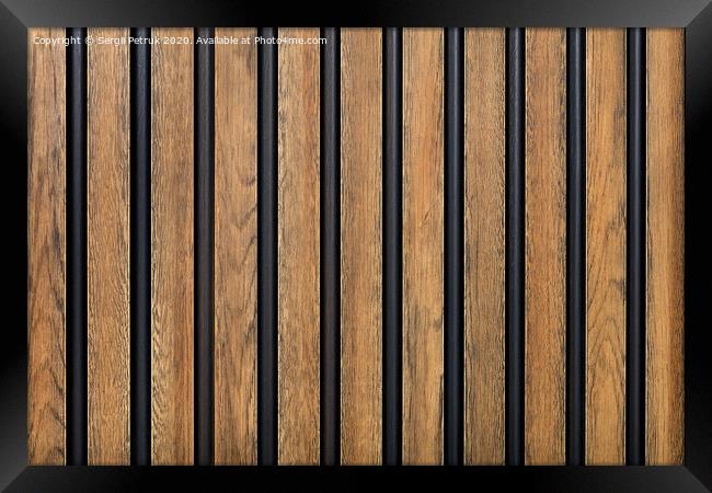 A fence made of vertical wooden decorative strips located parallel to each other. Framed Print by Sergii Petruk