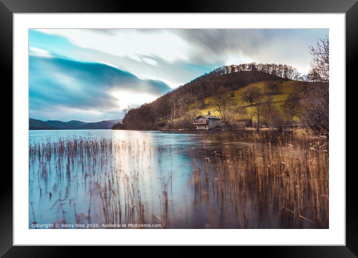 The boathouse through reeds Framed Mounted Print by Jonny Gios
