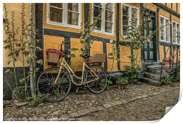 yellow bike leaning against a yellow half-timbered Print by Stig Alenäs