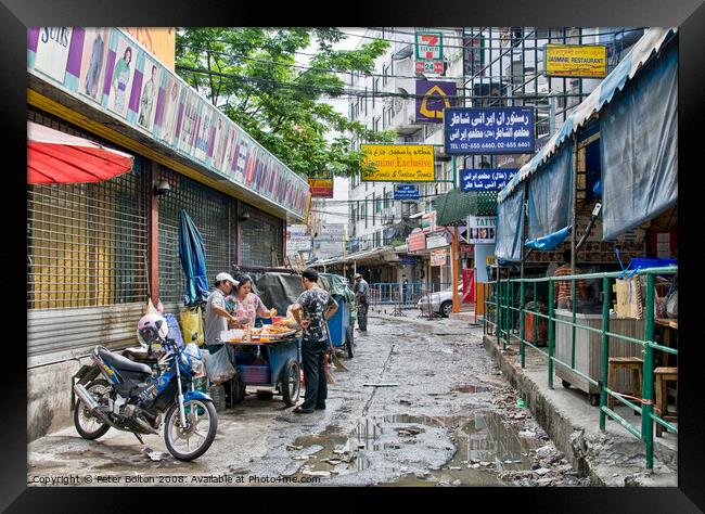 A side street in central Bangkok, Thailand, after heavy rain. Framed Print by Peter Bolton