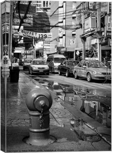 Bangkok street scene in the monsoon season Canvas Print by Peter Bolton