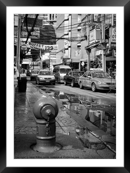 Bangkok street scene in the monsoon season Framed Mounted Print by Peter Bolton