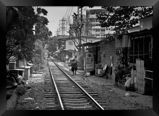 Railway track in central Bangkok, Thailand, with houses alongside. Framed Print by Peter Bolton