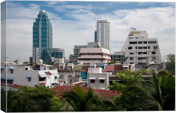 Cityscape of Bangkok, Thailand, showing dwellings and high rise buildings. Canvas Print by Peter Bolton