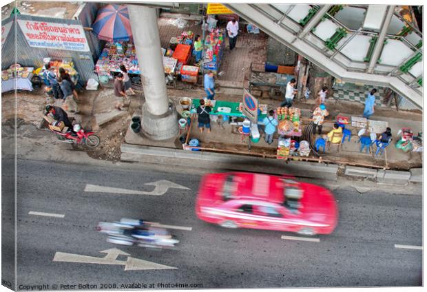 Overhead view of a street with food vendors and traffic speeding past. Bangkok, Thailand. Canvas Print by Peter Bolton