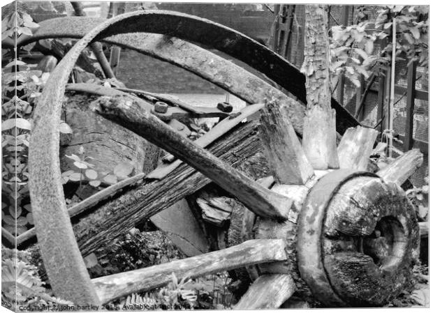 The Hub-Broken wooden cart wheel in Mono Canvas Print by john hartley