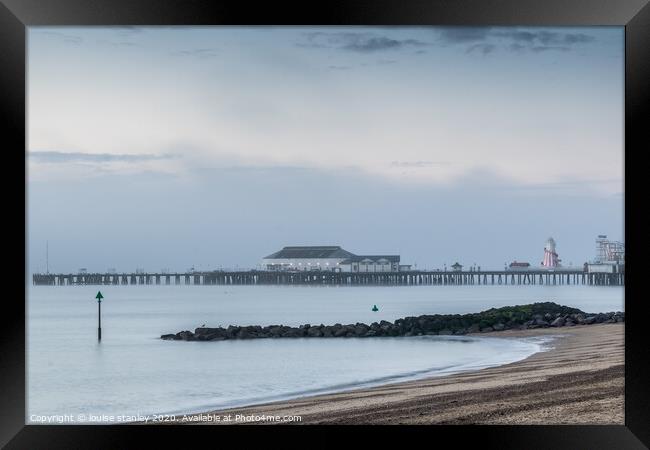 Clacton Pier as the Morning mist clears Framed Print by louise stanley