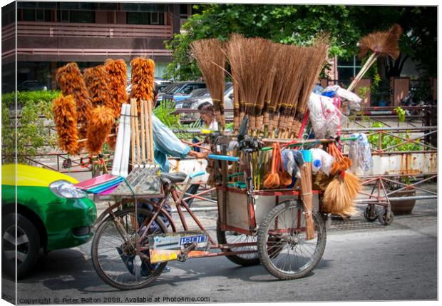Mobile street vendor selling brushes from a pedal tricycle in central Bangkok. Canvas Print by Peter Bolton