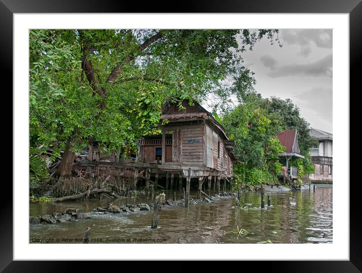 A typical dwelling on one of the canals off the Chao Phraya river, Bangkok. Framed Mounted Print by Peter Bolton