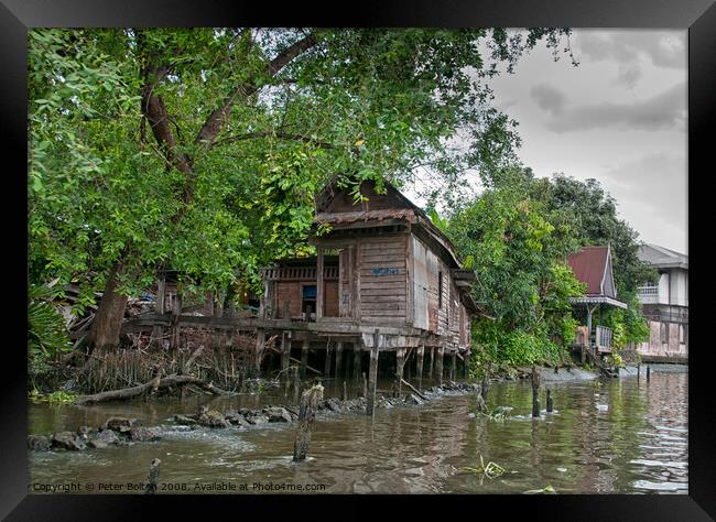 A typical dwelling on one of the canals off the Chao Phraya river, Bangkok. Framed Print by Peter Bolton