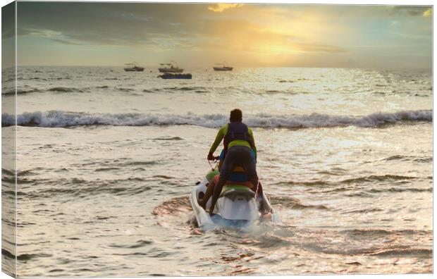 Goa, India - October 25, 2018: A jet ski moving swiftly against waves towards sunset in an arabian sea. Water sports adventure in Goa Canvas Print by Arpan Bhatia