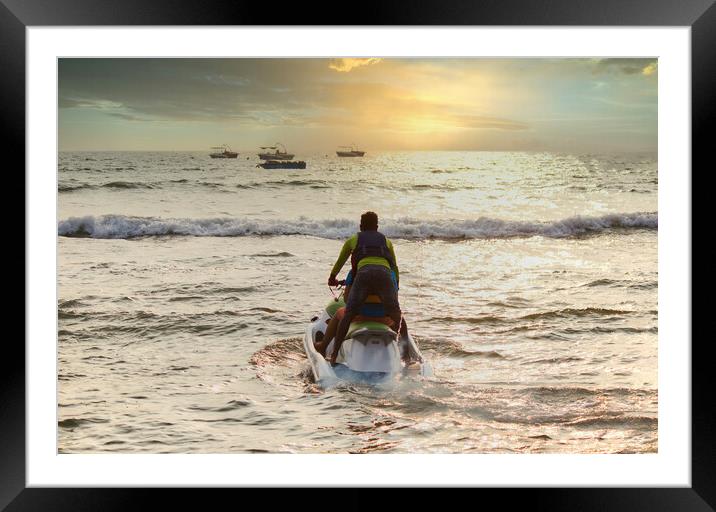 Goa, India - October 25, 2018: A jet ski moving swiftly against waves towards sunset in an arabian sea. Water sports adventure in Goa Framed Mounted Print by Arpan Bhatia