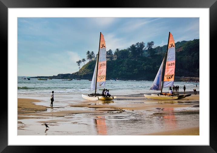 Goa, India - October 25, 2018: Sailing boat kept on a seashore beach with it's reflection on water during evening. Commercial beach of Goa. Framed Mounted Print by Arpan Bhatia