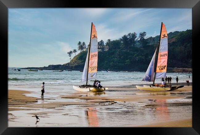 Goa, India - October 25, 2018: Sailing boat kept on a seashore beach with it's reflection on water during evening. Commercial beach of Goa. Framed Print by Arpan Bhatia