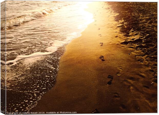 Human footprints on a sandy shoreline Canvas Print by Valerio Rosati