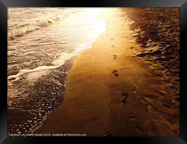 Human footprints on a sandy shoreline Framed Print by Valerio Rosati