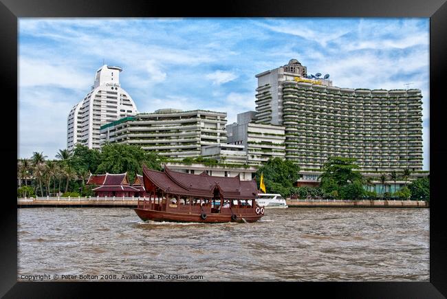 A tourist junk passing condominium towers on Chao Phraya river, Bangkok, Thailand. Framed Print by Peter Bolton