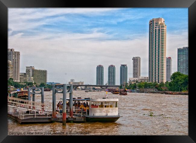 Ferry terminal with cityscape on the Chao Phraya River, Bangkok, Thailand. Framed Print by Peter Bolton