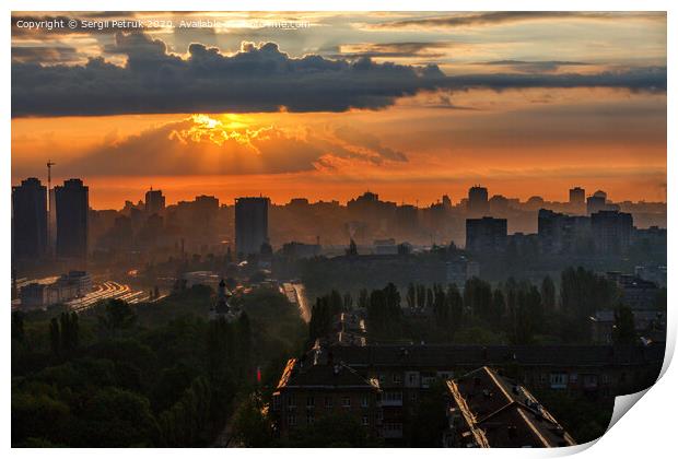 The sun's rays break through the rain clouds of a cloud at dawn and illuminate a sleeping city. Print by Sergii Petruk