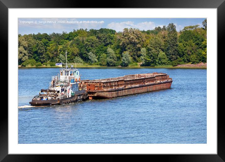 A river tugboat with an empty rusty barge goes crosses a wide river. Framed Mounted Print by Sergii Petruk