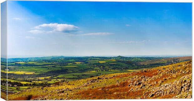 Brentor and Cornwall from Cox Tor, Dartmoor. Canvas Print by Maggie McCall