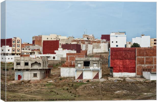 Urban dwellings near Tetoun, Morocco. Canvas Print by Peter Bolton