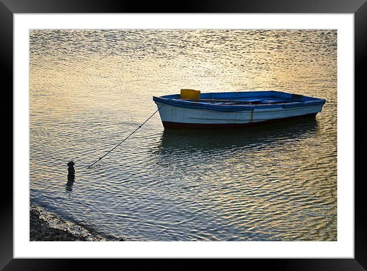 boat tied Framed Mounted Print by Hassan Najmy