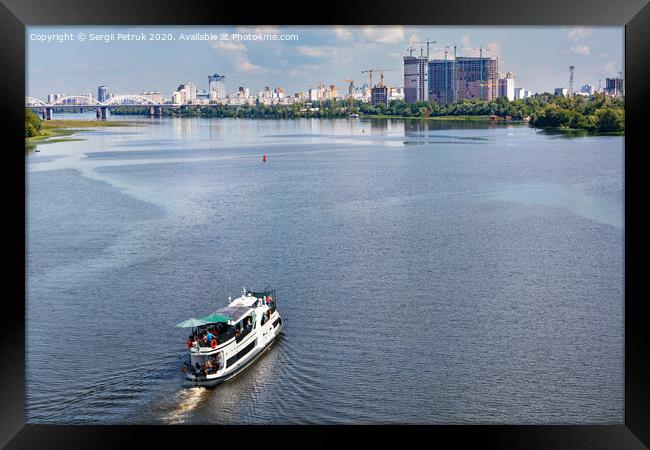 A river tram carries tourists along the Dnipro River along the left bank of Kyiv, top view. Framed Print by Sergii Petruk