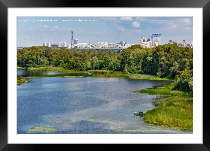 Natural picturesque landscape of the Dnipro bay near one of the river islands. An industrial city is visible in the background. Framed Mounted Print by Sergii Petruk