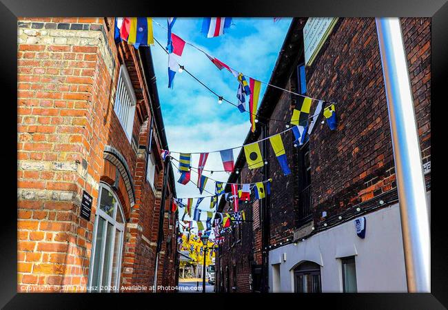 Outdoor street with flags  Framed Print by Julia Janusz