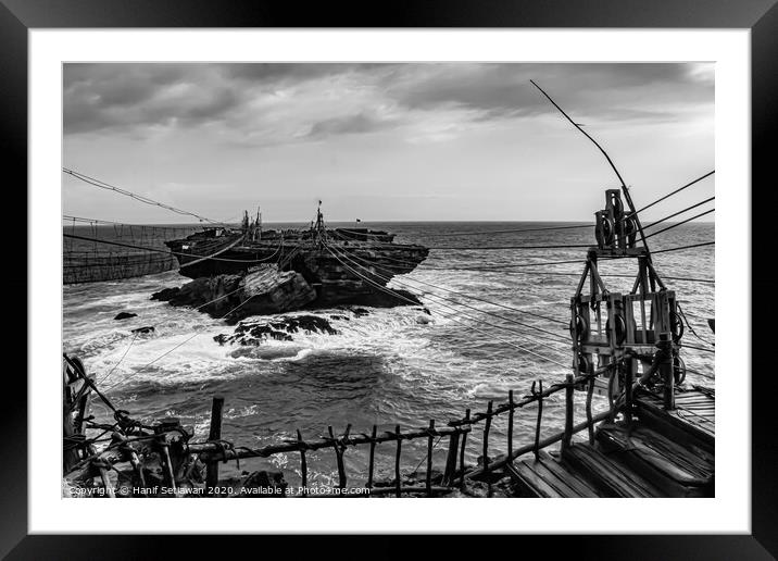 Rope foot bridge and cable car to a rock island. Framed Mounted Print by Hanif Setiawan