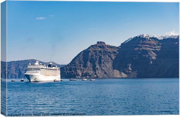 Cruise liner at anchor in Santorini Bay. Canvas Print by Chris North